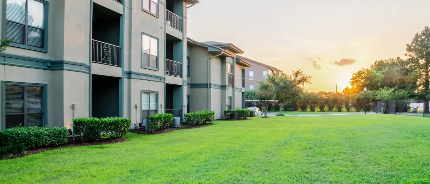 Clean apartment complex courtyard with green lawn